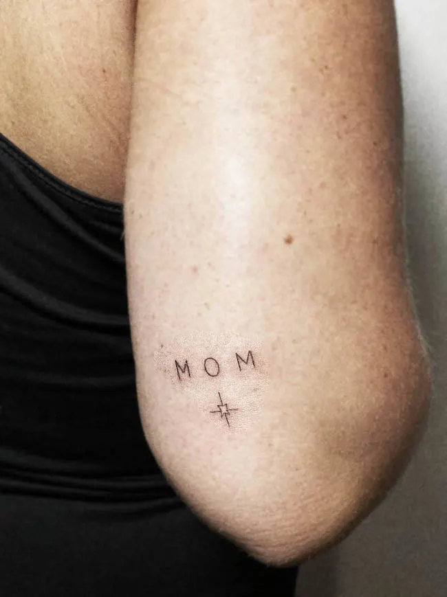 Small mom and star elbow tattoo by @salon_halo